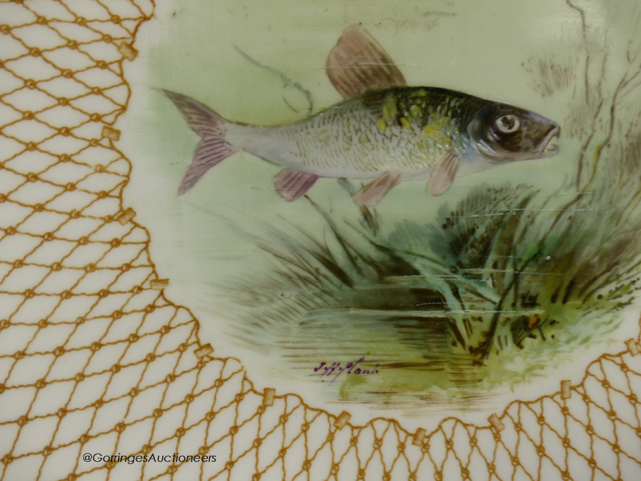 A Wedgwood pair of plates painted with named fish by J.H.Plant, signed